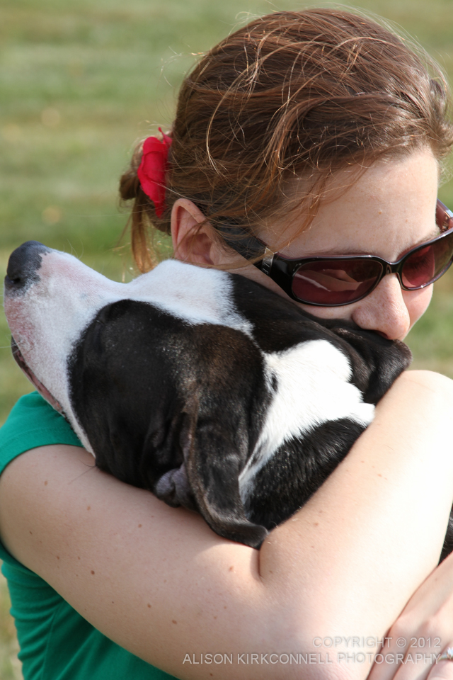Dog rescuer Colleen Lundergan hugs Bryce, a rescued pit bull